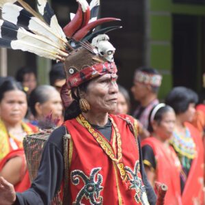 Vibrant celebration of Dayak culture with traditional costumes and rituals in Kalimantan Barat, Indonesia.